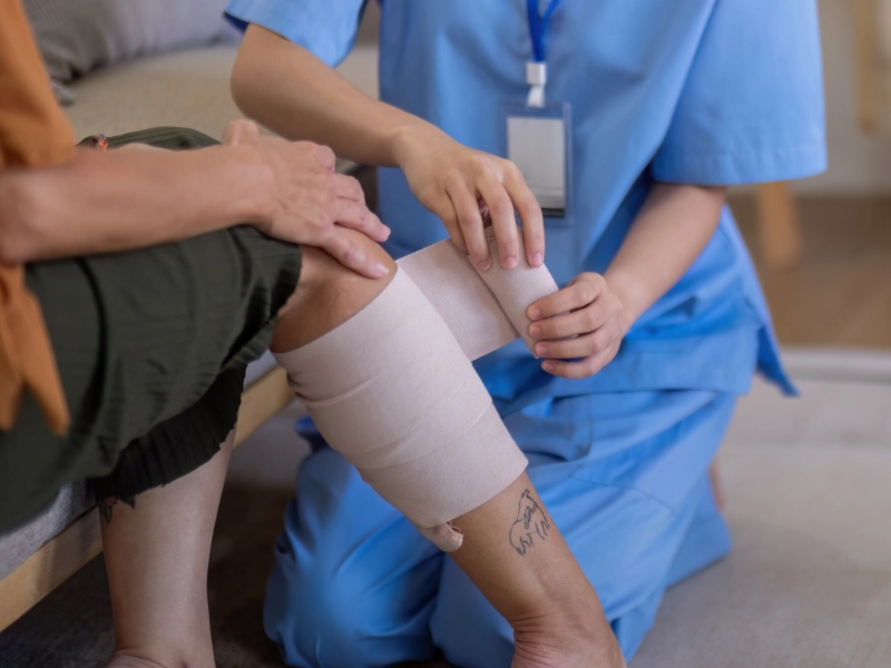 Clinician using portable mist therapy machine in a patient